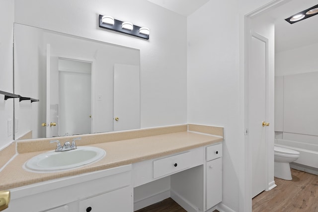 full bathroom featuring vanity, toilet, shower / bathtub combination, and hardwood / wood-style flooring