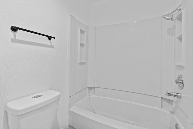 bathroom featuring toilet and  shower combination