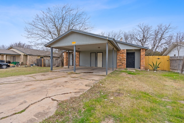 view of front of property featuring a front yard and a carport