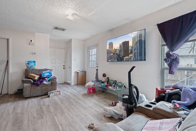 interior space with light hardwood / wood-style floors and a textured ceiling