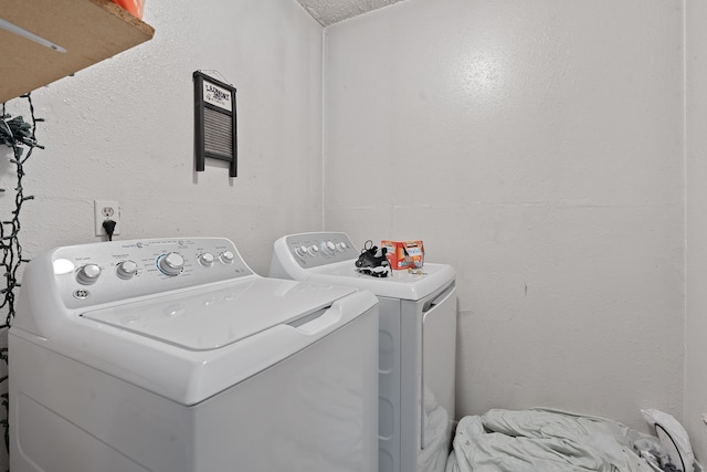 washroom featuring washing machine and dryer