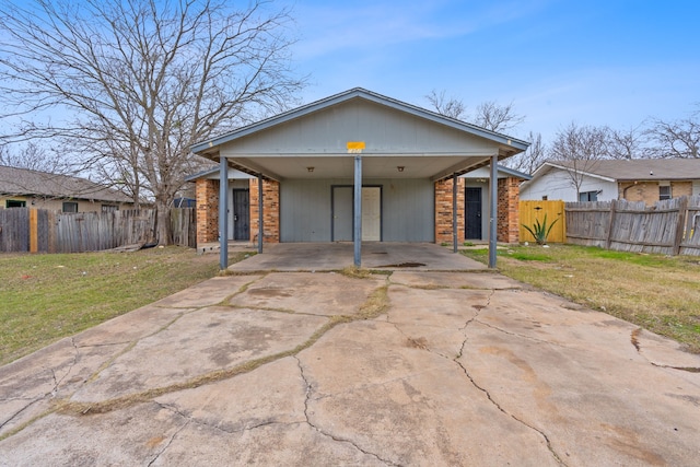 view of front of house with a front lawn and a carport