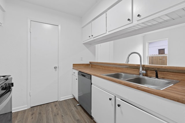 kitchen with white cabinets, stainless steel appliances, hardwood / wood-style flooring, and sink