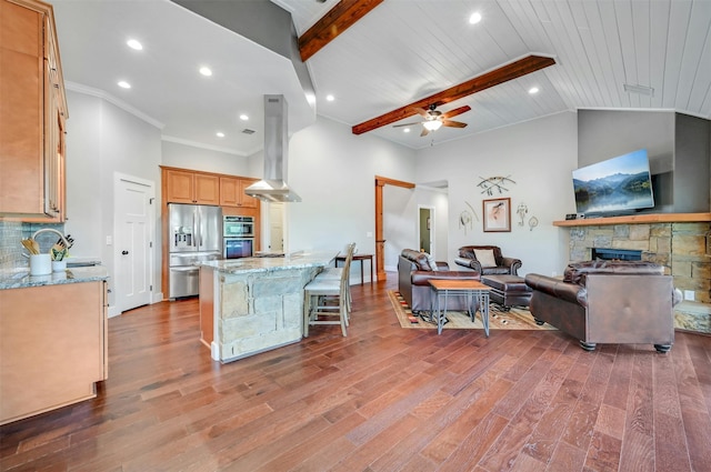 kitchen with a spacious island, island exhaust hood, light stone countertops, wooden ceiling, and stainless steel appliances