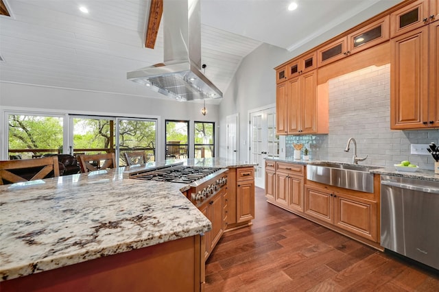 kitchen with light stone countertops, appliances with stainless steel finishes, island exhaust hood, sink, and beam ceiling