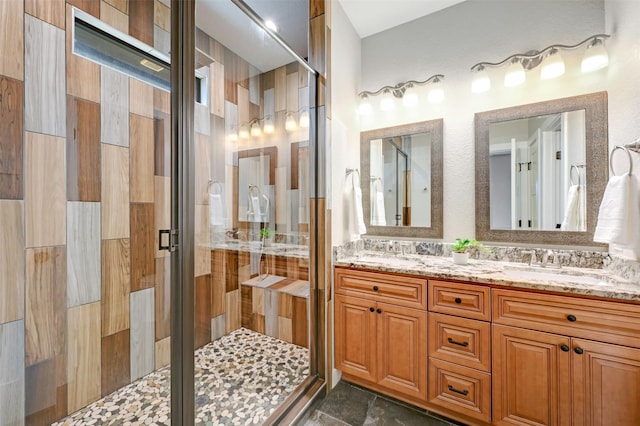 bathroom featuring vanity and a shower with door