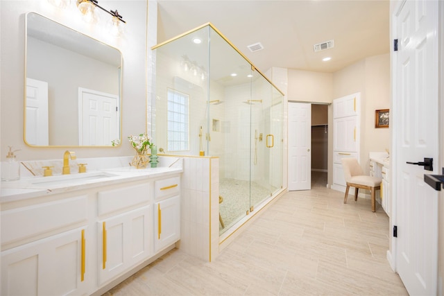 bathroom featuring vanity and an enclosed shower