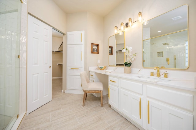 bathroom with tile patterned floors, an enclosed shower, and vanity