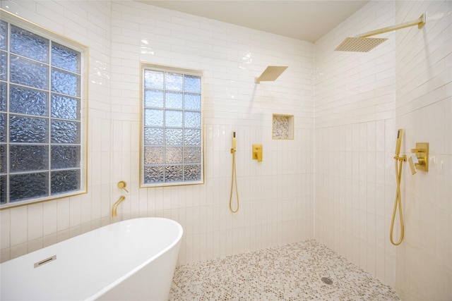 bathroom featuring tile walls and independent shower and bath