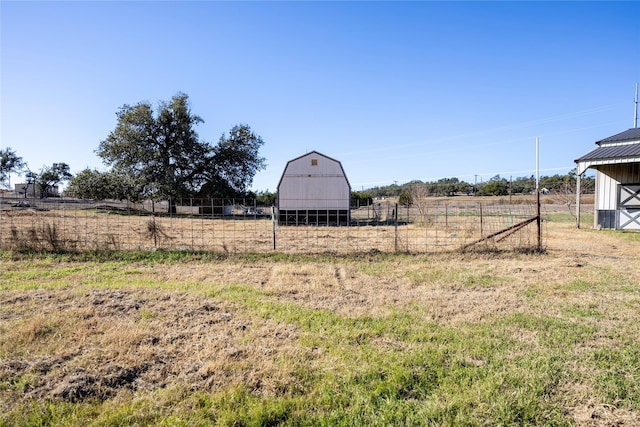 view of yard with an outbuilding and a rural view