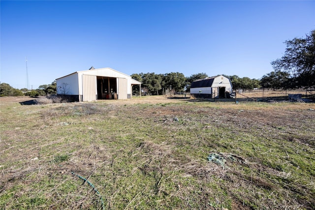 view of yard featuring an outbuilding and a rural view