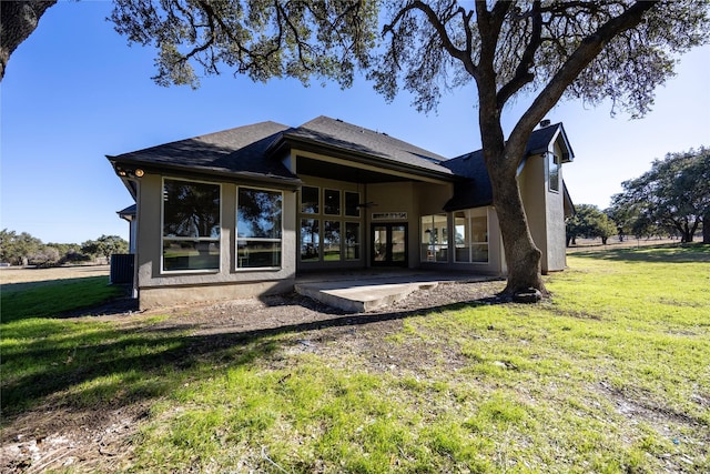 back of property with a patio area and a lawn