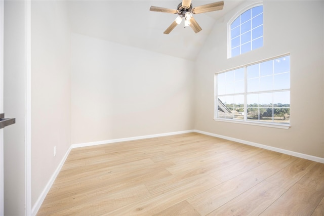 unfurnished room featuring lofted ceiling, light wood-type flooring, and ceiling fan