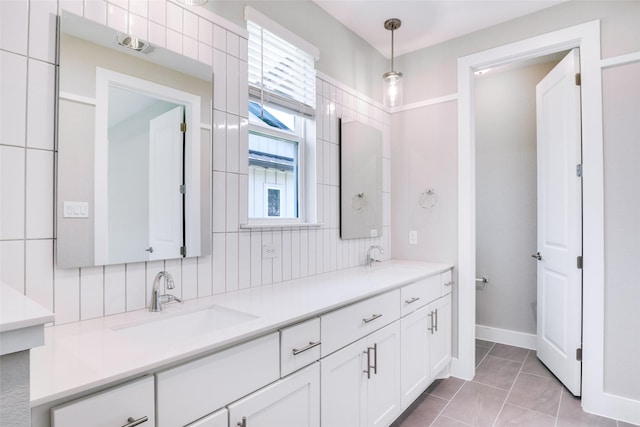 bathroom featuring tile patterned flooring, vanity, and tasteful backsplash