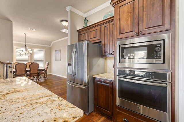 kitchen featuring light stone counters, ornamental molding, stainless steel appliances, and dark hardwood / wood-style flooring