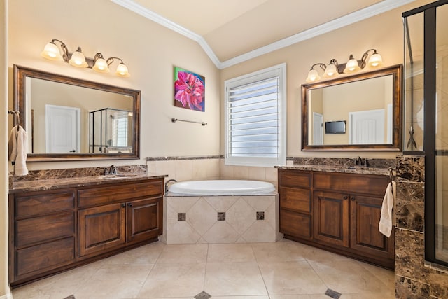 bathroom featuring tile patterned flooring, vanity, lofted ceiling, and a relaxing tiled tub