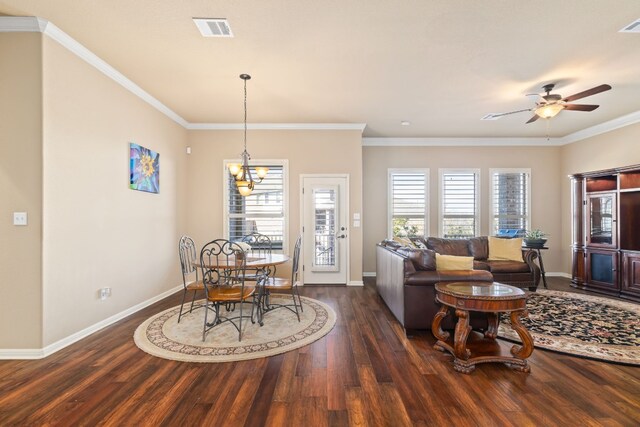 dining space featuring crown molding, dark hardwood / wood-style flooring, and ceiling fan with notable chandelier