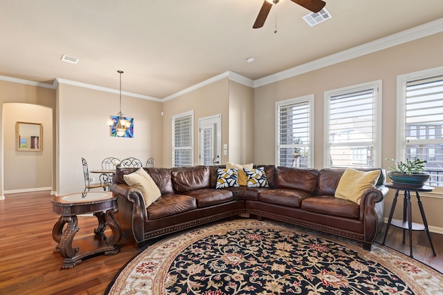 living room featuring ornamental molding, hardwood / wood-style floors, and ceiling fan