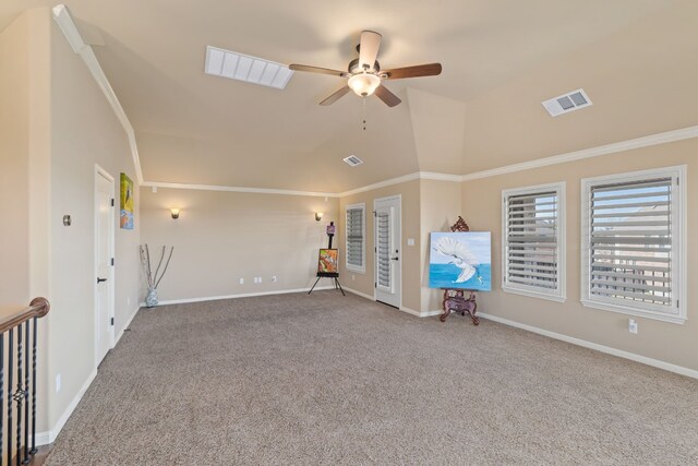 carpeted empty room with lofted ceiling, visible vents, and crown molding