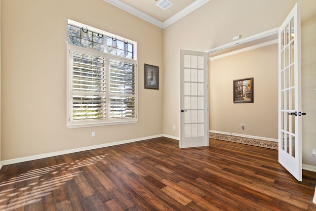 empty room featuring ornamental molding, french doors, dark wood-style flooring, and visible vents