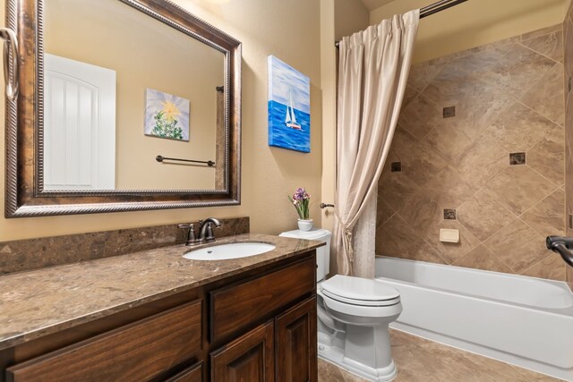 full bathroom with tile patterned flooring, shower / tub combo with curtain, vanity, and toilet