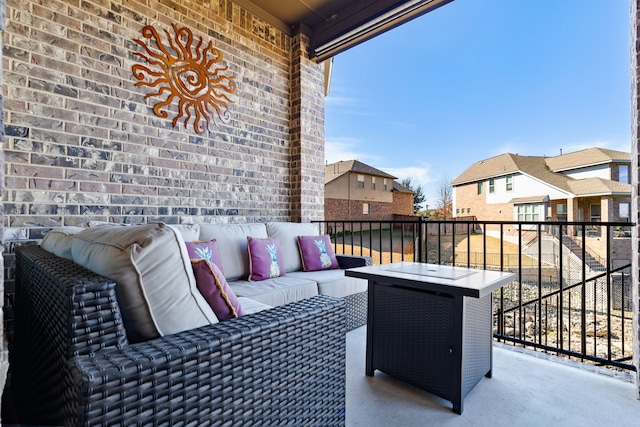 view of patio featuring a balcony and an outdoor hangout area