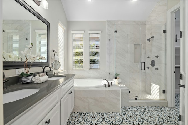 bathroom featuring separate shower and tub, tile patterned floors, lofted ceiling, and vanity