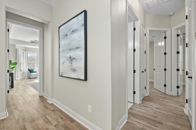 11716 Shadestone Ter, Austin, TX 78732 - corridor featuring light wood-style floors, baseboards, and crown molding