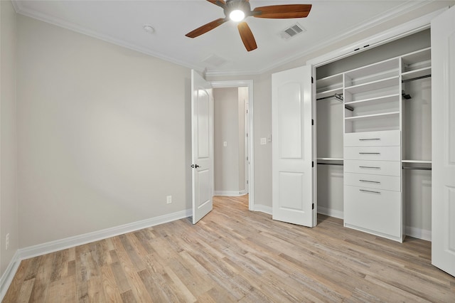 unfurnished bedroom with crown molding, light wood-type flooring, a closet, and ceiling fan