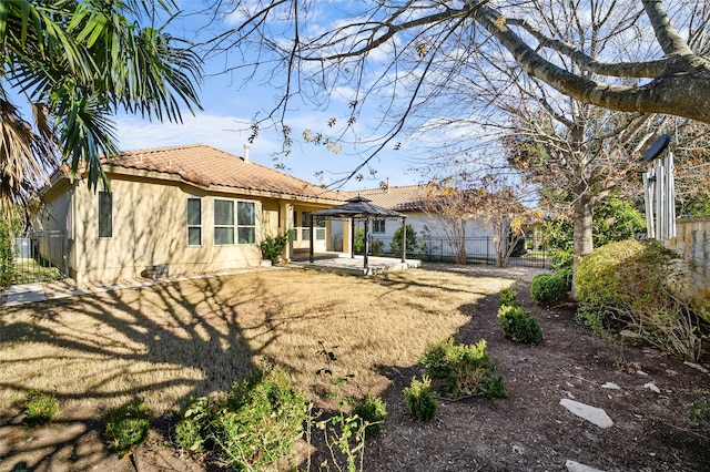 back of property featuring a patio and a yard