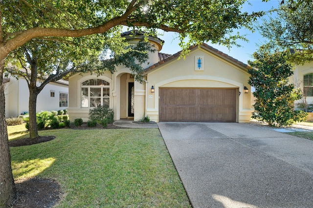 view of front facade with a garage and a front lawn