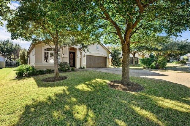 view of front of house with a garage and a front lawn