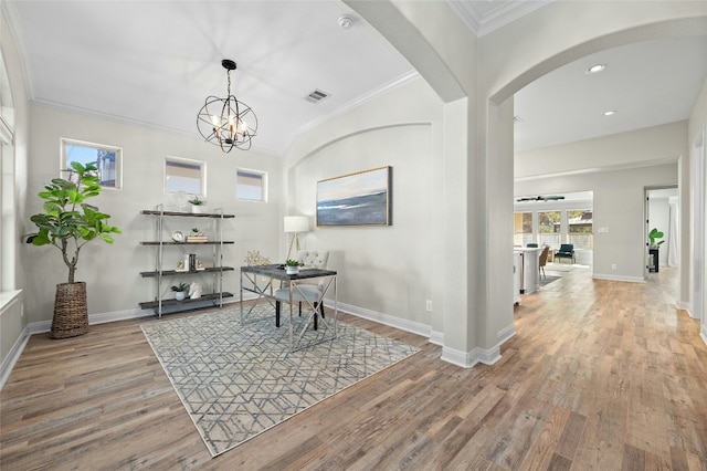 11716 Shadestone Ter, Austin, TX 78732 - dining room featuring wood finished floors, crown molding, arched walkways, baseboards, and recessed lighting
