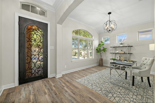 11716 Shadestone Ter, Austin, TX 78732 - entryway featuring wood finished floors, arched walkways, crown molding, baseboards, and a chandelier