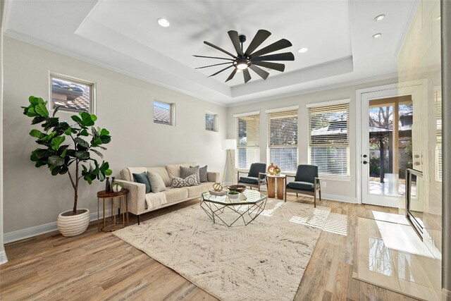 11716 Shadestone Ter, Austin, TX 78732 - living area featuring a tray ceiling, a ceiling fan, ornamental molding, recessed lighting, and light wood finished floors