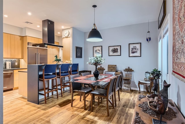 dining space featuring light hardwood / wood-style floors