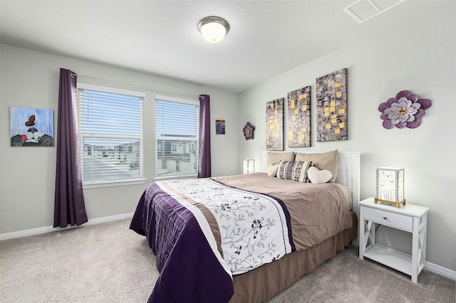 bedroom with carpet flooring, visible vents, and baseboards