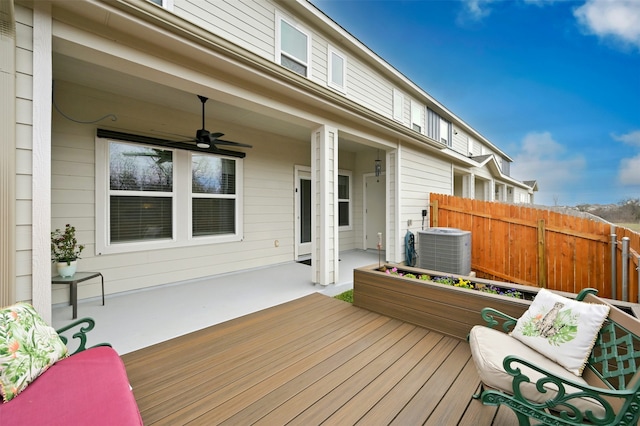 wooden deck with ceiling fan, cooling unit, and fence