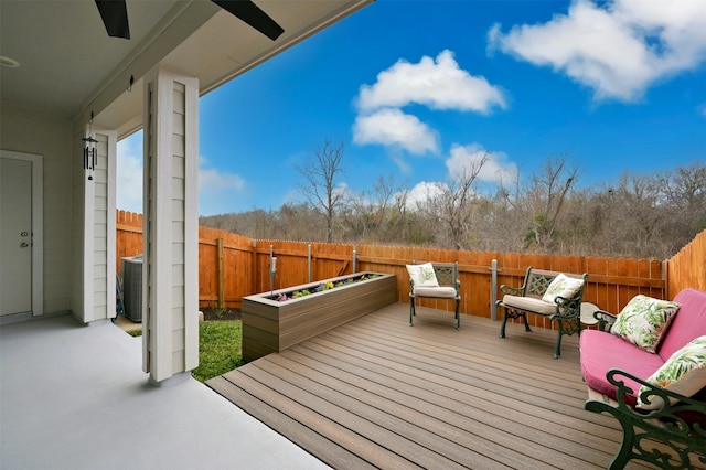 deck with a fenced backyard and a ceiling fan