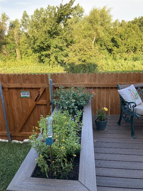 deck featuring a gate and fence