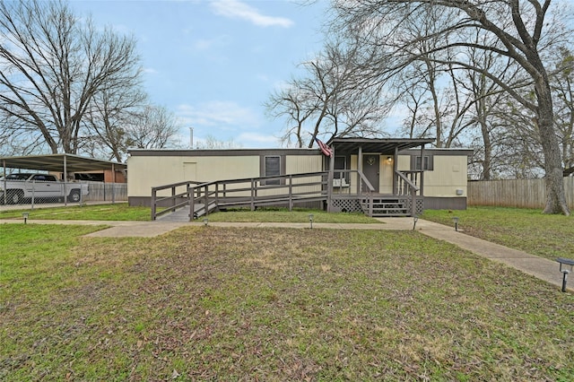 manufactured / mobile home with a deck and a front lawn