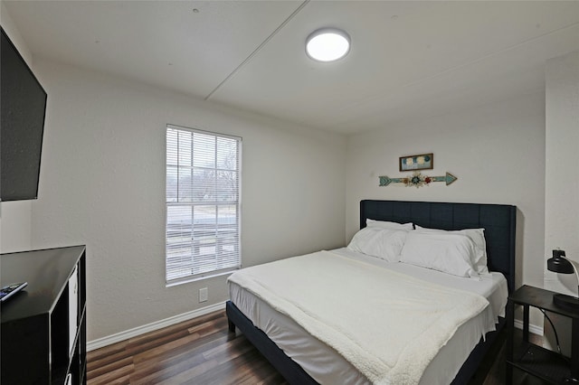 bedroom with dark wood-type flooring