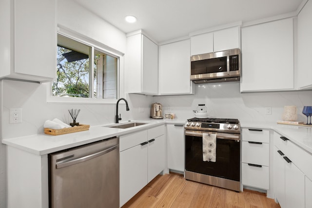 kitchen with sink, white cabinetry, and appliances with stainless steel finishes