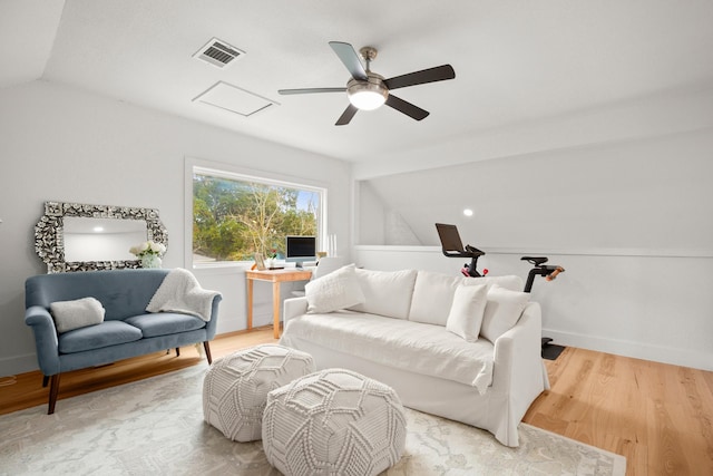 living room featuring light wood-type flooring, vaulted ceiling, and ceiling fan