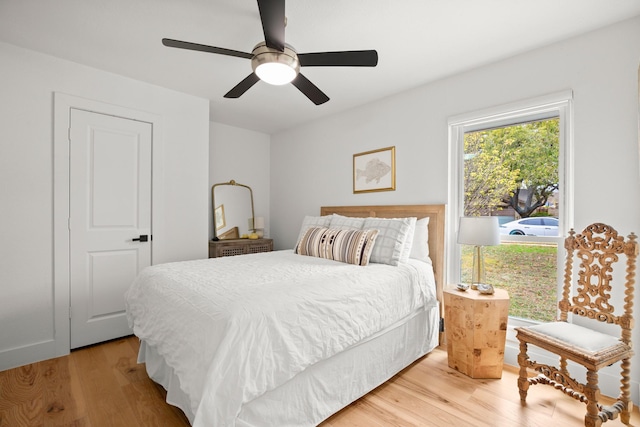 bedroom with ceiling fan and light hardwood / wood-style flooring