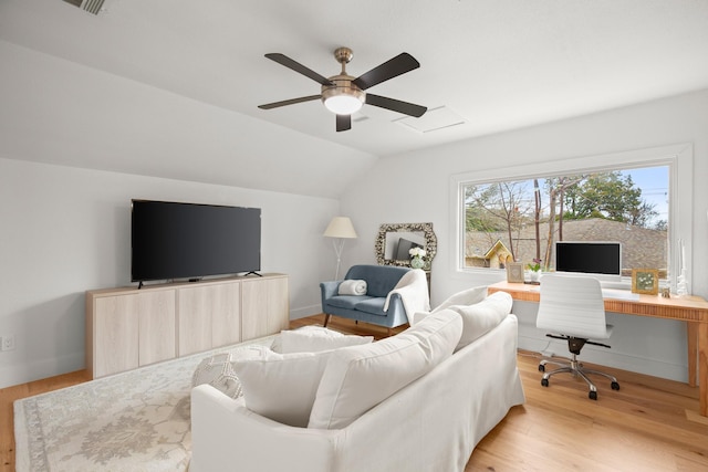 living room with ceiling fan, light hardwood / wood-style flooring, and lofted ceiling