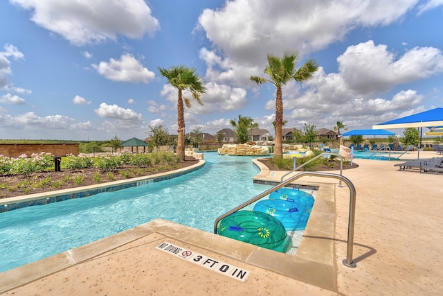 view of swimming pool with a patio