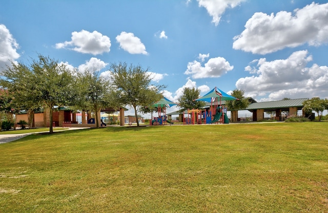 view of property's community featuring a playground and a lawn