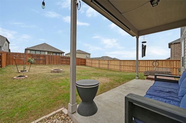 view of yard featuring a fire pit and a patio