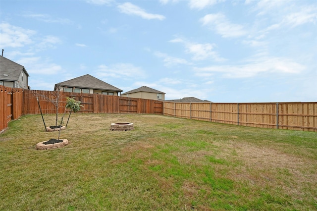 view of yard with an outdoor fire pit